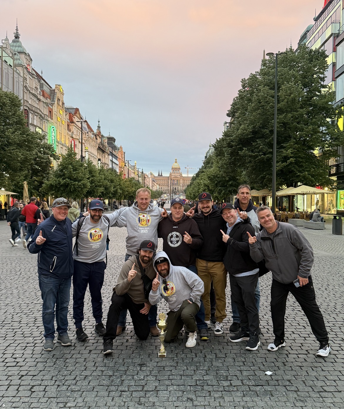 Team celebrating with trophy in Prague