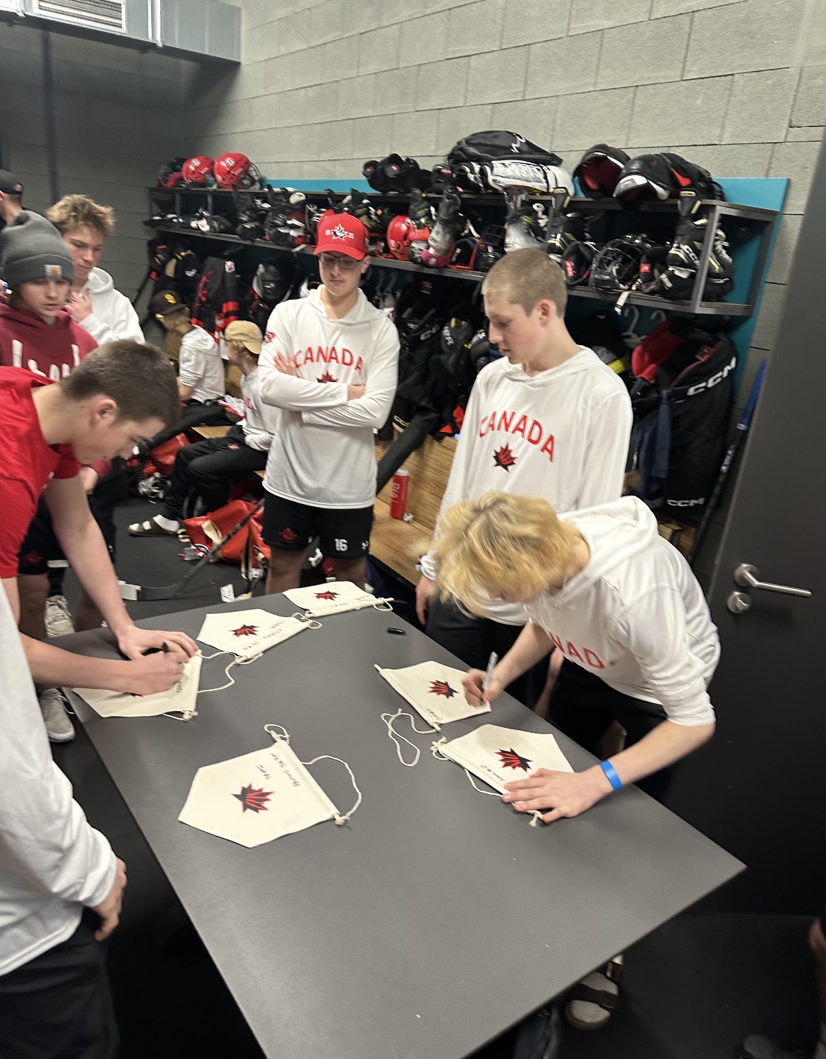Players signing pennants in locker room