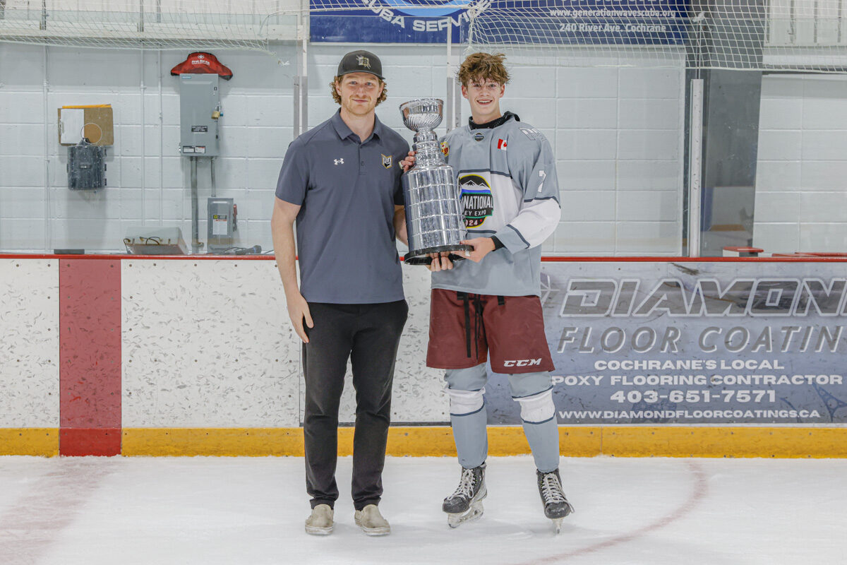 P3 player with championship trophy and coach