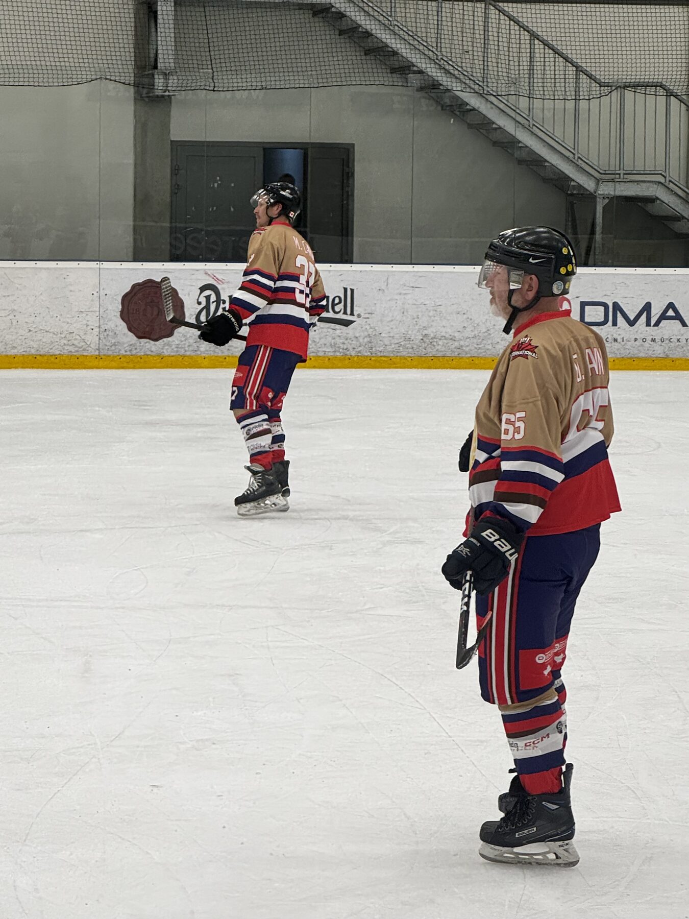 Rusty Mitts players on the ice between shifts