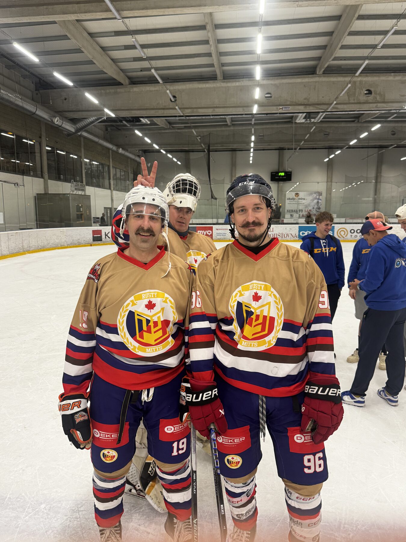 Rusty Mitts teammates #19 and #96 post-game on Czech ice